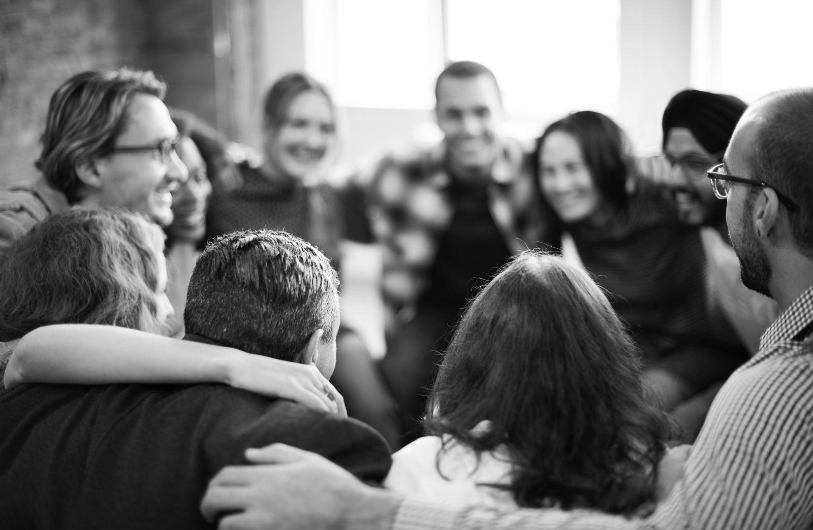 people in a group huddle customer support