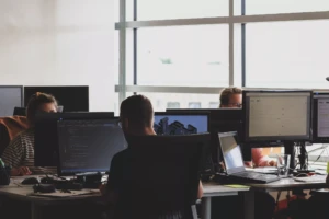 Photo of a couple of co-workers sitting at their desks