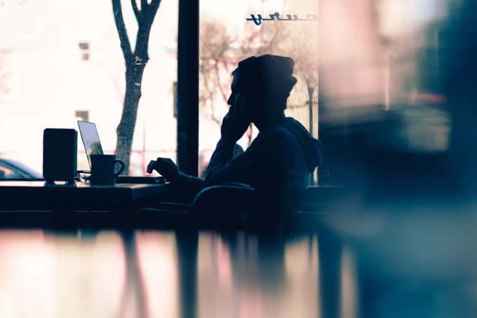 Photo of a backlit man at a coffee shop