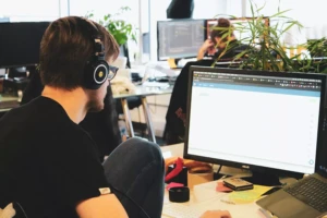 Photo of a man focused with his headphones on