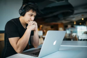 Man in deep thoughts looking at his laptop