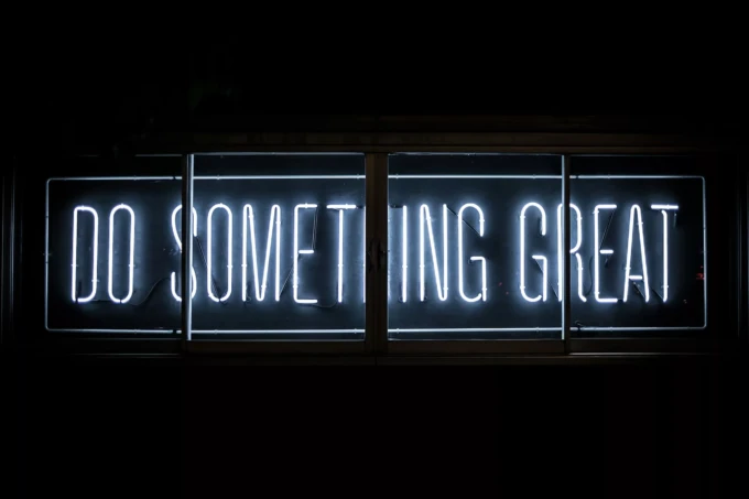 A neon sign with the words do something great