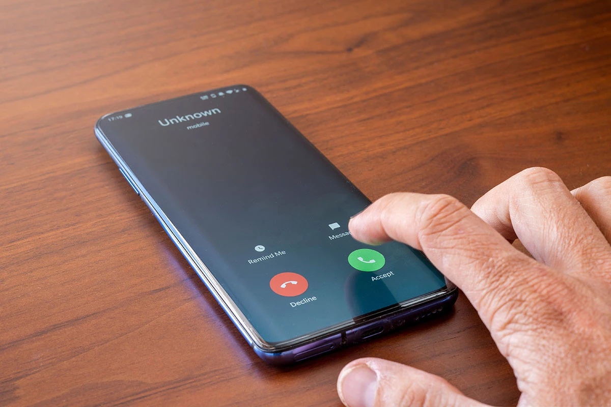 Photo depicting an incoming phone call from an unknown caller on a mobile phone