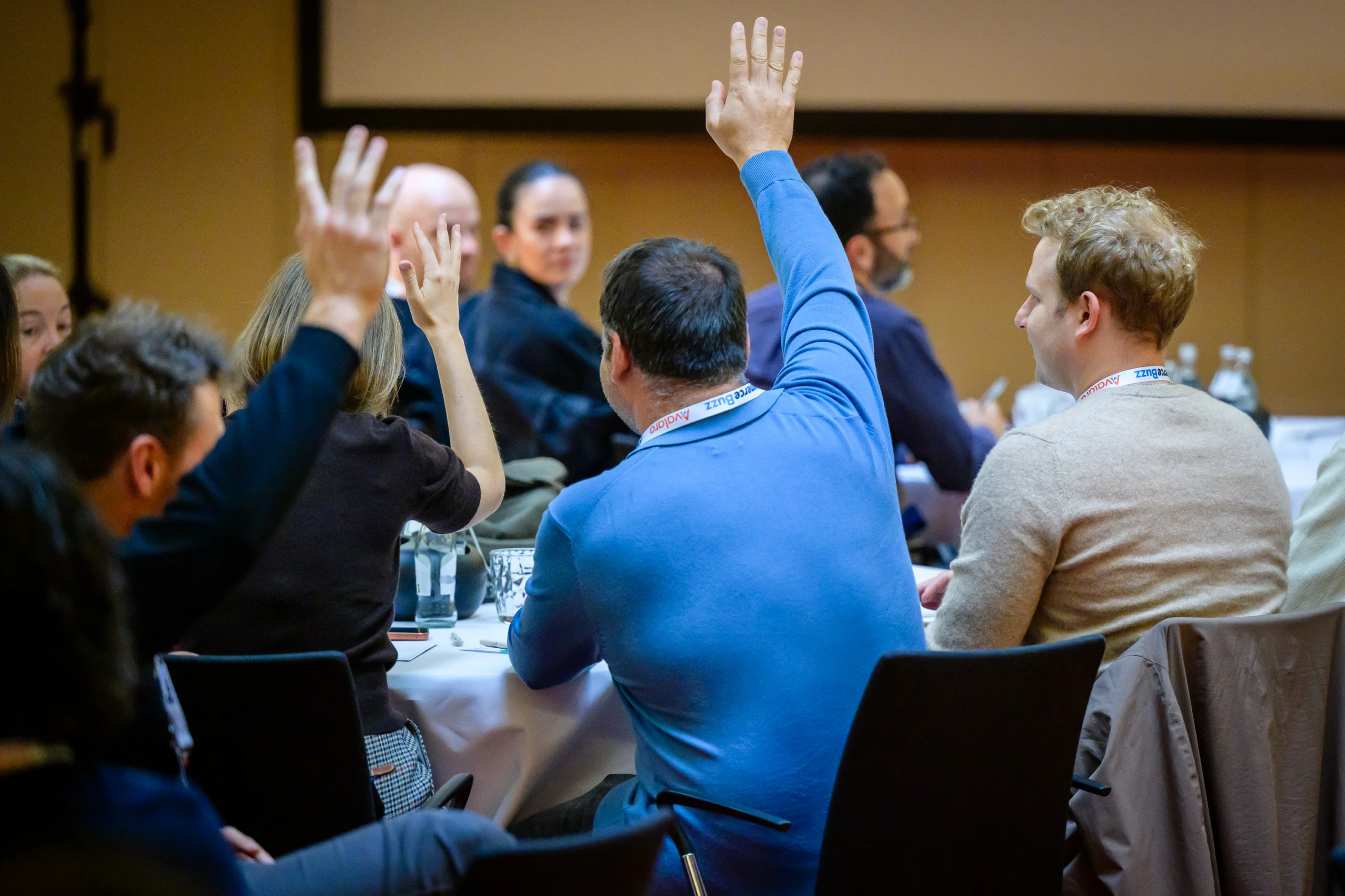 audience at recommerce berlin raising hands at besedo panel Q&A